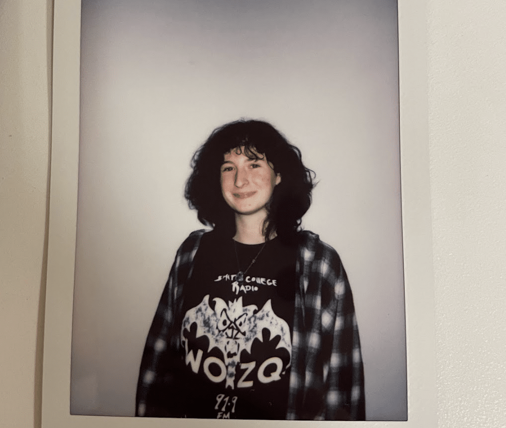 Polaroid image of the author of this article wearing a Smith College Radio t-shirt